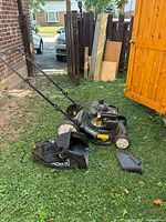 Full mower with handle, bag and chute on grass