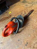 Side view of Black & Decker corded hedge trimmer showing housing, handle and blade