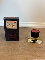 True Religion Drifter box beside Hummer H2 bottle