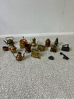 Group shot of all miniature metal kitchen pieces on carpet
