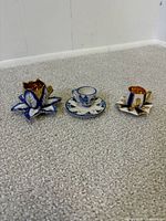 All three miniature teacups displayed on carpeted floor