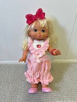 Full view of PJ Sparkles doll standing, showing complete outfit and accessories