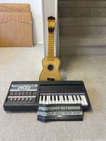 Keyboard, ukulele and booklet group shot