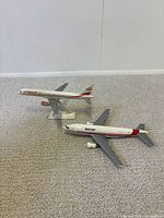 Both miniature planes side by side on carpet