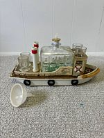 full view of boat caddy with decanter, stopper, shot glasses and funnel