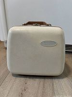 Closed beige Westinghouse hard case with handle