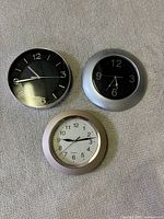 All three wall clocks side by side