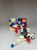 Assembled Lego 6810 Laser Ranger in foreground with instruction booklet in background