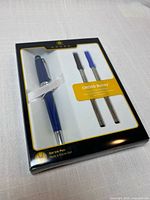 Retail package front showing pen and two refills