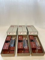 Three boxed C&BT Shops kits opened to show contents