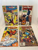 All four comic books laid out front covers visible