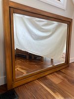 Front view of rectangular mirror showing wood frame and glass