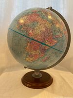 Front view of Replogle 12" blue ocean globe on wooden base
