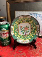 Front of saucer beside soda can for scale