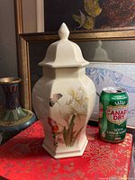 Front view of porcelain ginger jar with lid, soda can for scale