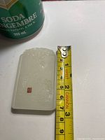 Pendant beside tape showing height just over 70 mm