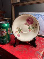 Front view of saucer showing floral design and gold rim