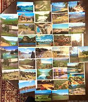 Overhead view of 40 Western Canada color postcards laid out in grid