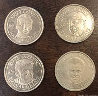 Obverse view of four tokens showing driver portraits and numbers