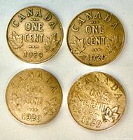 Reverse side of four 1929 Canadian one cent coins showing maple leaf design and dates
