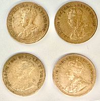 Four 1933 Canada one-cent coins obverse side