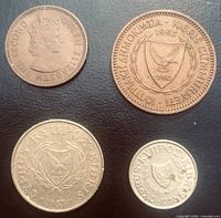 Obverse sides of all four coins showing portraits and Cyprus arms
