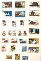 First album page with assorted Hungarian pictorial stamps covering subjects such as snail, horse-drawn carriage, windmill, huts, flowers, vehicles, space and sports