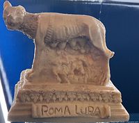 Front view showing ROMA LUPA inscription and figures beneath wolf