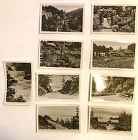 Nine black-and-white postcards laid out face up, showing front images