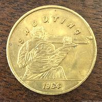 Obverse showing shooter with rifle and text SHOOTING 1984