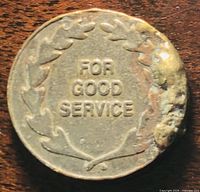 Reverse of coin showing “FOR GOOD SERVICE” within laurel wreath