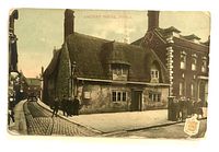 Front view of colour-tinted postcard showing Ancient House scene