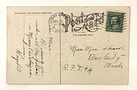 Reverse of postcard showing stamp, postmark, handwriting