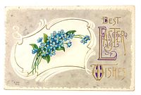 Front of postcard showing blue floral bouquet and gold gilt lettering