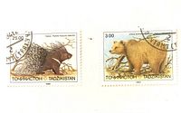 Two cancelled 1993 Tajikistan wildlife stamps showing porcupine and bear, denominations 25.00 and 3.00