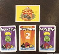 Front view showing Ultimate Upgrade mini card and fronts of three larger cards