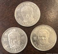 Obverse of three tokens showing driver portraits and legends