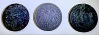 Three coins obverse side showing varying wear and corrosion