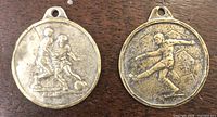 Obverse views of both soccer medals