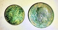 Both coins obverse sides showing green patina, size comparison