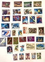 Overview of approximately 34 USSR pictorial commemorative postage stamps arranged in rows