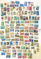 Full layout of assorted U.S. postage stamps on surface