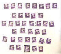 Full layout of approximately 34 violet “B” rate Eagle stamps, showing used and one mint in mount