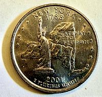 Reverse design with Statue of Liberty and state outline