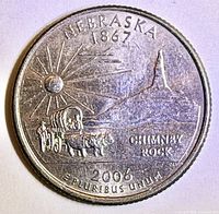 Reverse side of Nebraska 2006 quarter showing covered wagon, Chimney Rock, sunburst, inscriptions