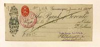 Front of Bank of Toronto draft showing engraved arms, date, payable details, war tax stamp, cancellation marks