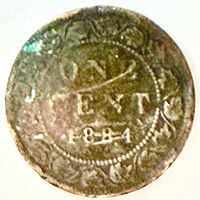 Reverse side displaying maple leaf wreath and date 1884