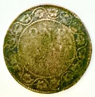 Reverse side of worn Canada Edward VII one cent coin showing maple leaf wreath