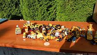 Overview of assorted yellow toy construction vehicles spread on table