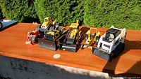 Front view of all six construction toys aligned on table